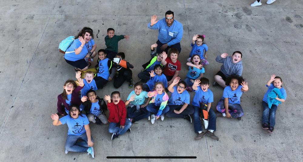 Floresville Electric Light & Power System - FELPS Lineman Joe waving with the class of 2028 at Floresville ISD’s Career Fair